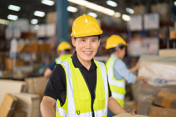 Teamwork of Asian workers working in large warehouse store industry.Rack of stock storage. Interior of cargo in ecommerce and logistic concept. Depot. People lifestyle. Shipment service for container