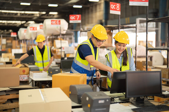 Teamwork of Asian workers working in large warehouse store industry.Rack of stock storage. Interior of cargo in ecommerce and logistic concept. Depot. People lifestyle. Shipment service for container