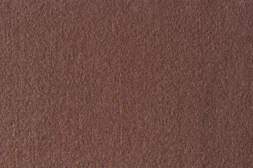 Brown color felt textile fabric material texture background. Abstract monochrome dark brown color...