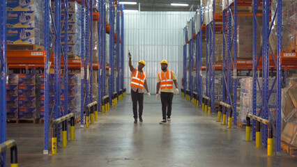 Teamwork of Black workers working in large warehouse store industry.Rack of stock storage. Interior of cargo in ecommerce and logistic concept. Depot. People lifestyle. Shipment service for container