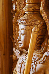 wood carving of Buddha on the wall