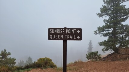 sunrise point sign at foggy bryce canyon