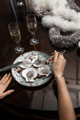 girl eating oysters with decorations for dinner