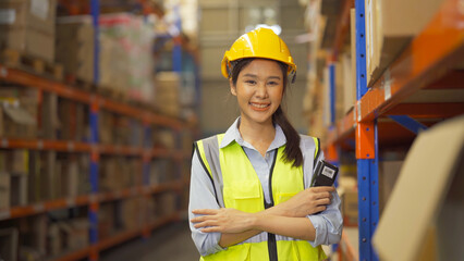 Portrait of Asian woman worker working in large warehouse retail store industry factory. Rack of stock storage. Cargo in ecommerce and logistic concept. Depot. People lifestyle. Shipment service.