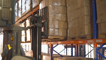 Fork lift truck with pallet car vehicle working of large warehouse retail store industry. Rack of furniture and stock storage. Interior of cargo in ecommerce and logistic concept. Depot transportation