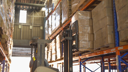 Fork lift truck with pallet car vehicle working of large warehouse retail store industry. Rack of furniture and stock storage. Interior of cargo in ecommerce and logistic concept. Depot transportation