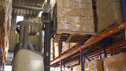 Fork lift truck with pallet car vehicle working of large warehouse retail store industry. Rack of furniture and stock storage. Interior of cargo in ecommerce and logistic concept. Depot transportation