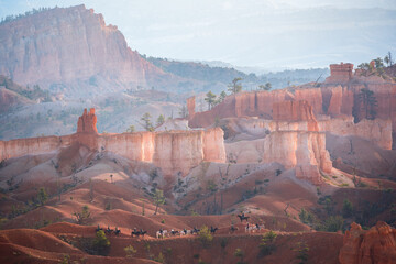 horse riders in bryce canyon at sunrise