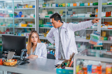 Male doctor angry at female pharmacist while working in pharmacy