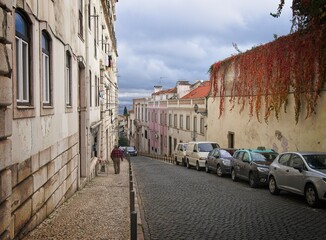 Lisbon street in Graca district winds down to the Tagus River