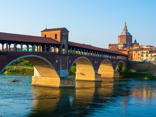 Fototapeta na wymiar The Ponte Coperto is a bridge over the Ticino river in Pavia, it is one of the symbols of the city of Pavia, it has five arches, it is completely covered with two portals at the ends