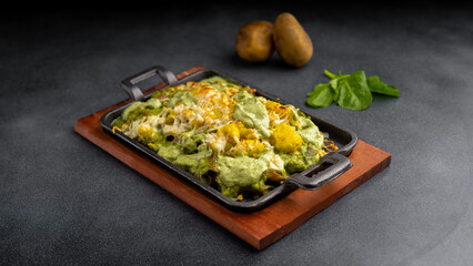 chicken spinach pasta baked in oven with cheese and mashed potato served in dish isolated on table top view of arabic food