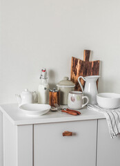 Scandinavian style kitchen interior. Dishes on a white cabinet. Cooking. Cozy kitchen
