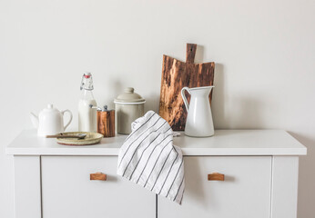 Scandinavian style cuisine. White furniture, white dishes. Cozy kitchen still life