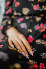 Vertical photo of girl hand with pink manicure