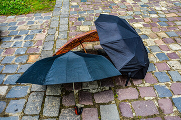 umbrellas lie outside on a stone walkway