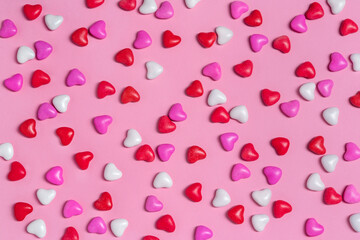 Candy hearts on pink background. Valentine's day. Holiday background