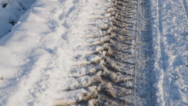 tractor tracks on snowed rural road road in winter