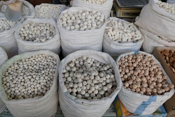 Big bags with kurut - dried cottage cheese in Osh Bazaar, central market in Bishkek, Kyrgyzstan.  
