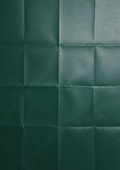 Texture of folded green paper, top view or detail scan, cool printed photo effect overlay via blend mode screen.
