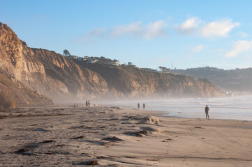 people on a foggy beach
