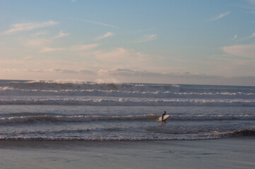Surfer getting out of the ocean