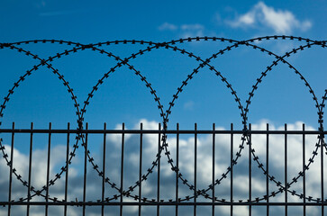 Barbed wire fence enclosing a closed area.