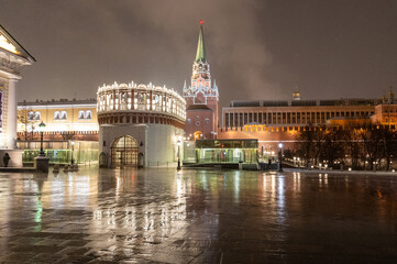 Obraz na płótnie Canvas Moscow, Russia - December 27, 2022: Tower of the Moscow Kremlin. Cold and deserted Moscow street on a snowy winter evening near Red Square