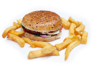 Tasty, fresh hamburger with french fries on a white table unhealthy food