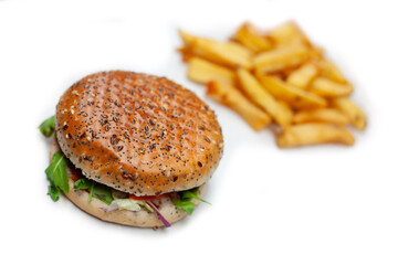 Tasty, fresh hamburger with french fries on a white table unhealthy food