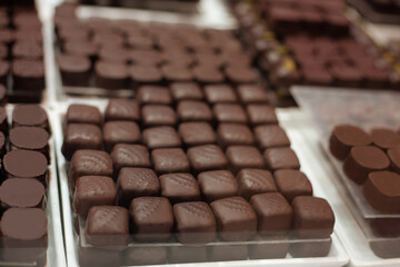 Delicious sweets and cookies made of black and brown chocolate on the festive table