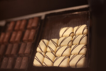 Delicious sweets and cookies made of black and brown chocolate on the festive table