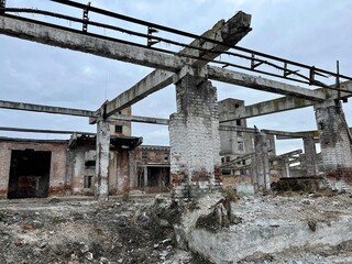 Fototapeta premium Vinnytsia Ukraine Chemist plant ruins and ruins of plant over time it looks more and more like shell hit and destroyed everything around there are no people no life only grass sprouts on bricks