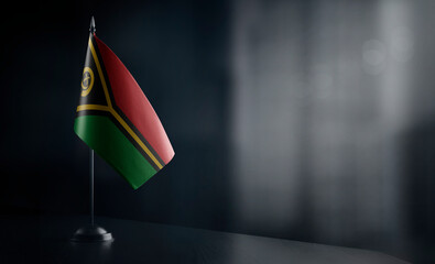 Small national flag of the Vanuatu on a black background