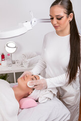 Obraz na płótnie Canvas esthetician performing facial cleansing, skin care concept, . High quality photo