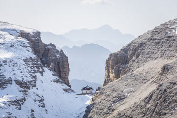 Spectacular mountain hut Forcella Pordoi between two spectactular rock walls in the Dolomites in Italy