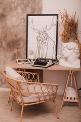 Stylish desktop with typewriter and picture. Bright home interior