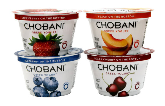 Four containers of Chobani Greek yogurt of different flavors, transparent PNG.