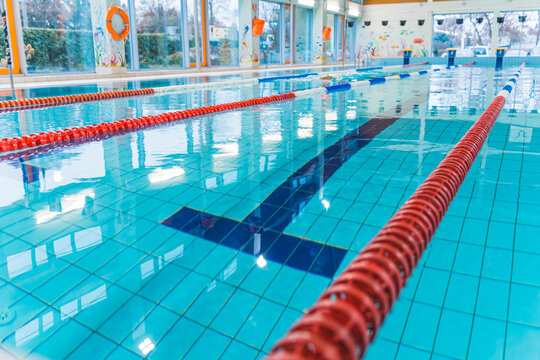 Indoor Public Swimming Pool Lanes Close-up To The Water. No People Swimming. High Quality Photo