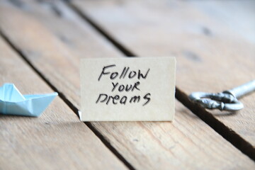 Follow your dreams text written on a tag.