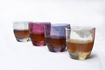 colored glass goblet with cognac and cheese