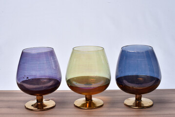 colored glass goblet with cognac and cheese