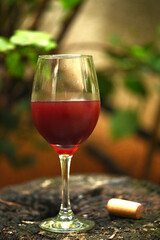 glass of red wine on a rustic wooden base grape juice