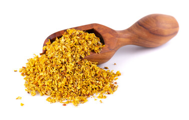 Osmanthus tea in wooden spoon, isolated on white background. Dry flowers of Osmanthus fragrans.