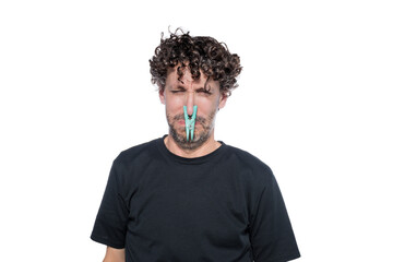 Middle-aged man with a brooch on his nose. Concept of bad smell.