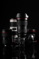 Fototapeta na wymiar Professional mirrorless camera with premium lenses in dark background