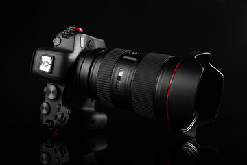 Professional mirrorless or dslr camera with premium lens in dark background