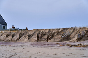 a damaged shoreline and broken stairs leading to the beach in the Hamptons