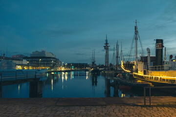 Sunset in Bremerhaven with houses and ships and the (bremer Schiffahrts-Museum), Klimahaus and the...