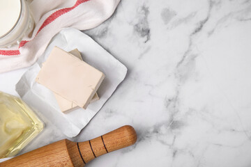 Yeast and food ingredients on white marble table, flat lay. Space for text